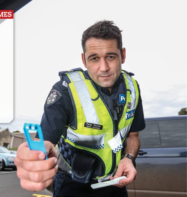 On the lookout: Warrnambool police highway patrol member Senior constable Peter Hunter prepares to administer a drug test. The unit's officers have an impressive strike rate. Picture: Christine Ansorge