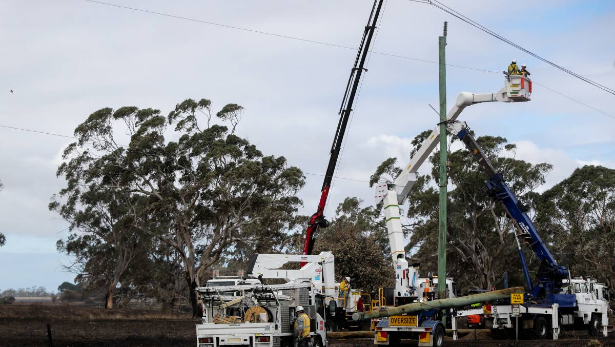 Men at work: Powercor workers replace power poles along Cobden-Warrnambool Road. Picture: Rob Gunstone