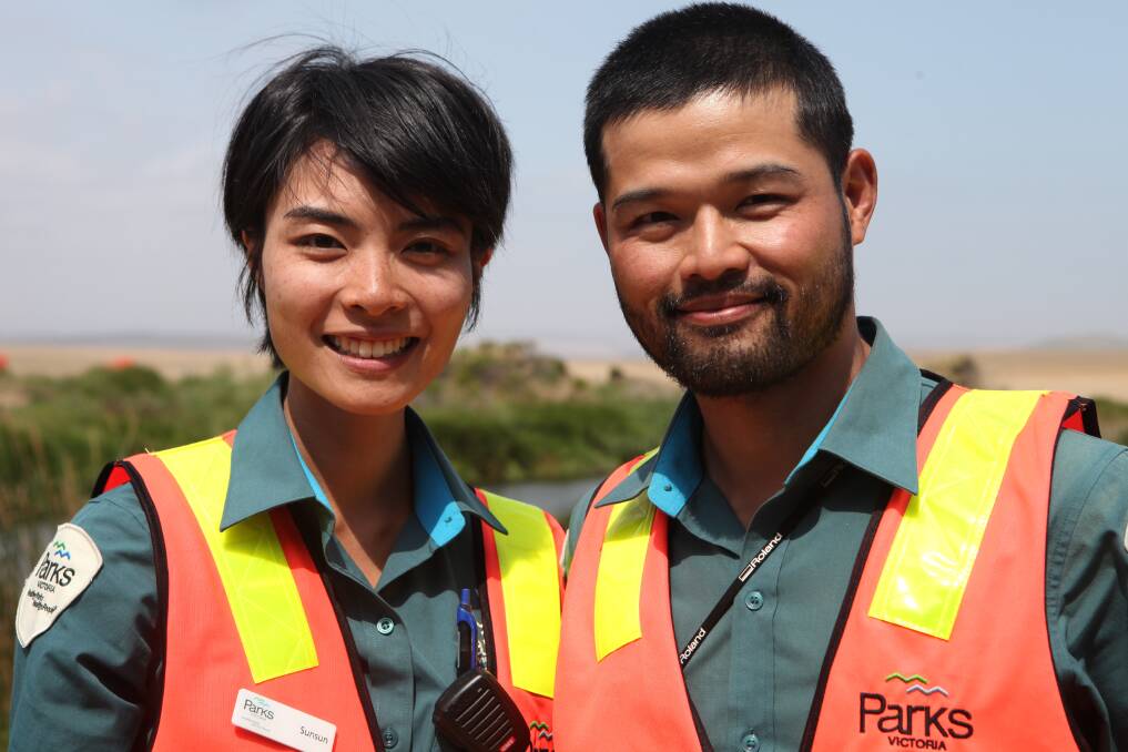 Here to help: Parks Victoria visitor engagement officer Sunsun Chen (left) and ranger Wenbo Chen, at the Twelve Apostles on Tuesday. Picture: Gus McCubbing