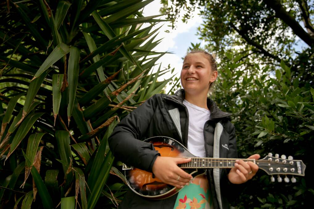 Koroit Lake School participant Yvette Harman, 15, from Geelong, playing mandolin in the Koroit Gardens. Picture: Chris Doheny 