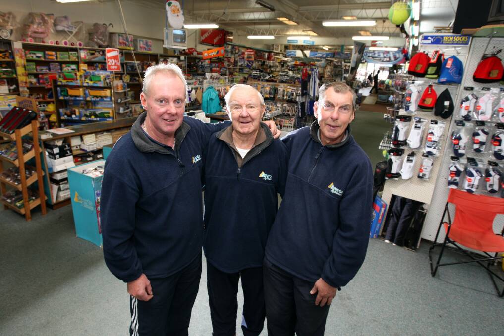 Cyril De Grandi (middle) with his sons Michael and John in the family store in 2011. File picture 
