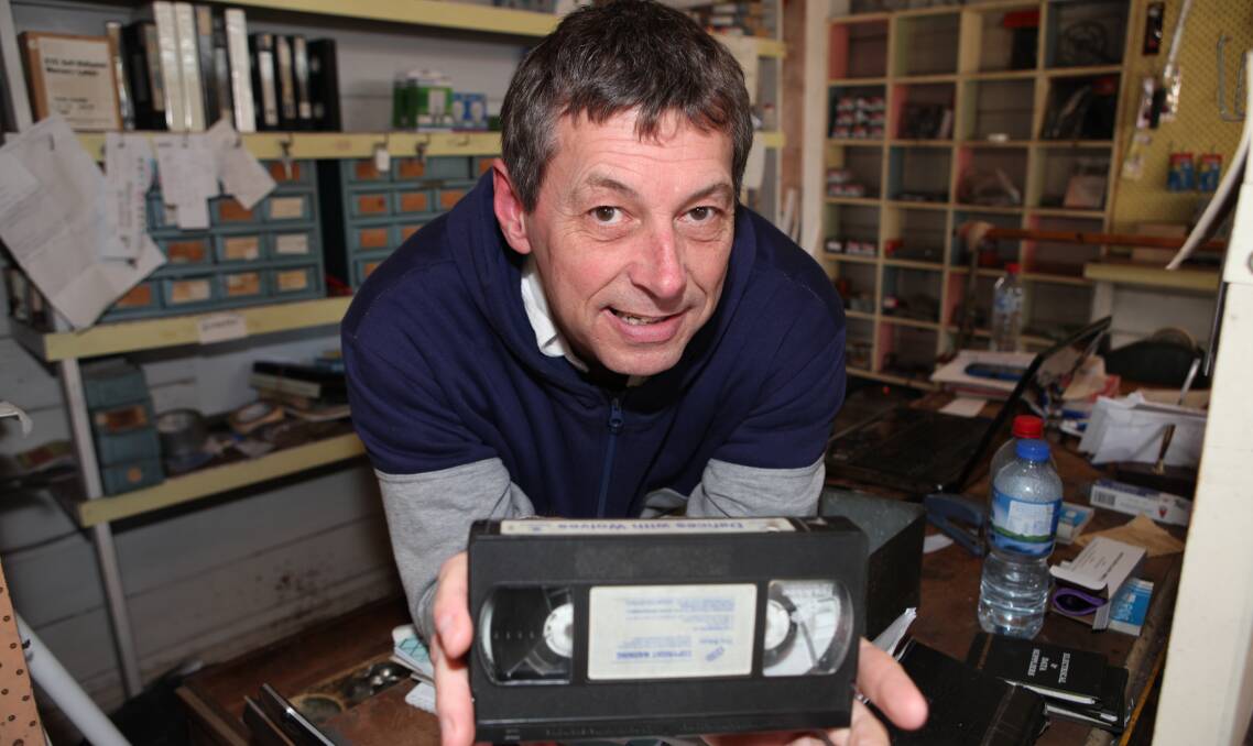 GLORY DAYS: Brad McLean from McLean's Electrical and Computer Solutions in Koroit with an old VHS tape. Mr McLean can remember when VHS was the star attraction of the home entertainment industry. Picture: Anthony Brady