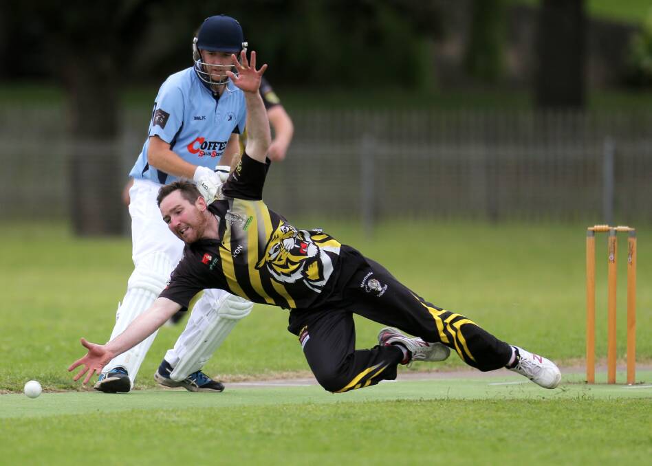 FULL STRETCH: Wesley-CBC's James McArdle watches on as Merrivale bowler Josh Stapleton dives to stop a straight drive. Picture: Rob Gunstone