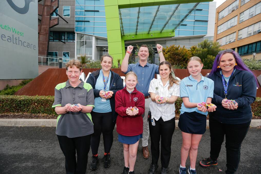 Julie Russell (South West Healthcare), Michelle Heard (TheirCare), Layla Tucker Warrnambool East Primary School), Dr Glen Saward (South West Healthcare), Jordyn Gervasoni (South West Healthcare), Emelia Tucker (Warrnambool East Primary School) Mel Healey (TheirCare) with the loom bands. Picture: Anthony Brady