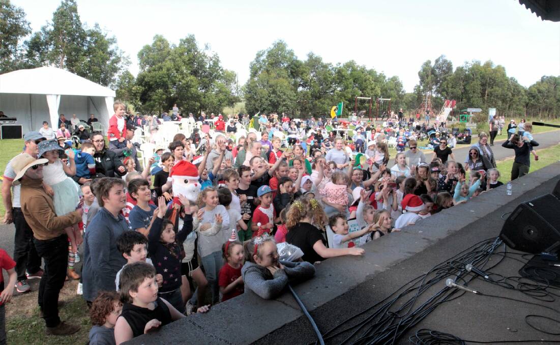 EXCITED: A swarm of children get ready for the Irish Santa to throw out some Christmas lollies at last year's Koroit Carols by the Railway. The event returns this Sunday.