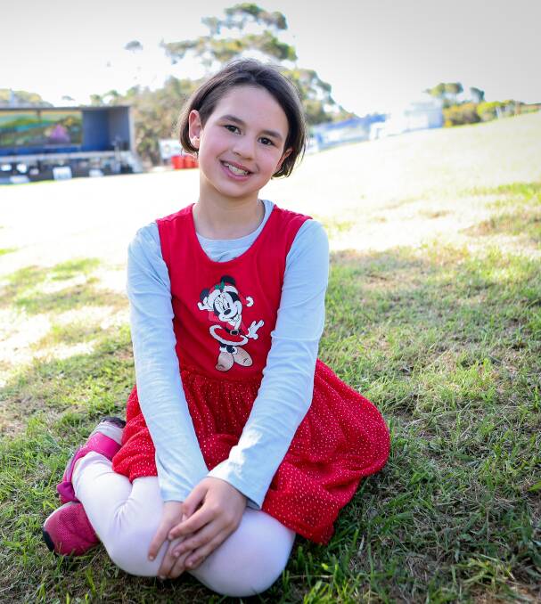 Kathryn Clarke, 8, got her spot early at the Carols by the Merri in Dennington on Friday night. The event was well attended. Picture by Anthony Brady