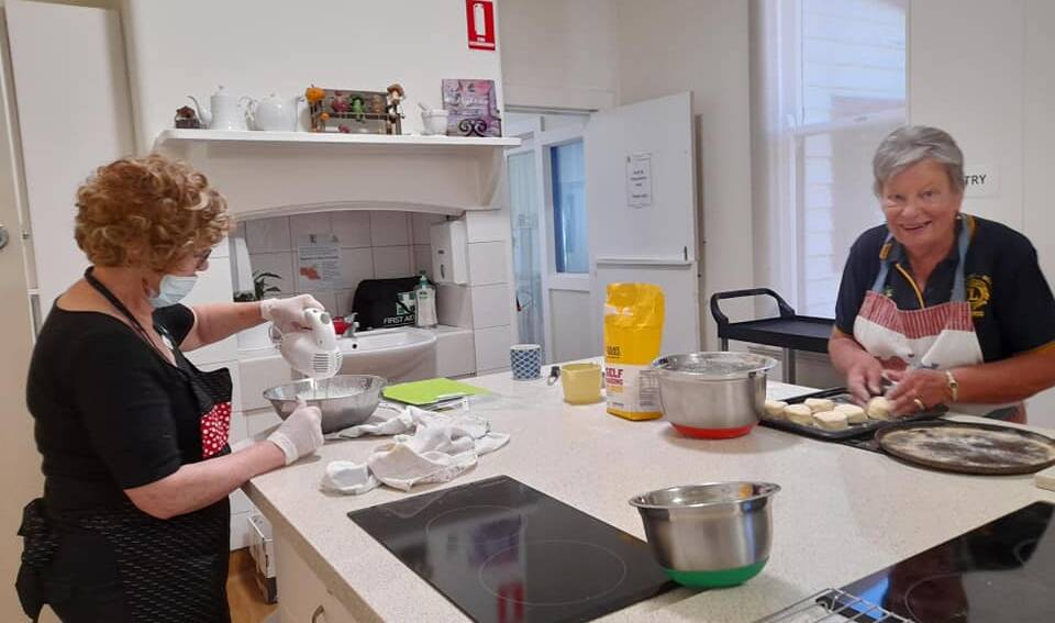 HOMEMADE: Port Fairy Belfast Lions Club members Lesley Dawson and Chris Hetherington cooking up some scones in the community house kitchen.