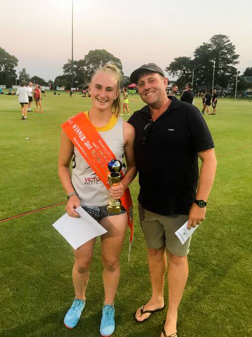 VICTORY: Layla Watson with the spoils from her 300-metres win at Parkdale Gift meeting. With her is coach Wayne Perry. 