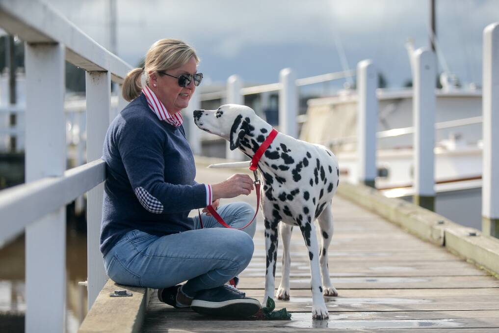 FRIENDSHIP: Port Fairy's Cate Melville with her beloved Dalmatian Ellie enjoying a walk in the sun along the wharf. Picture: Mark Witte
