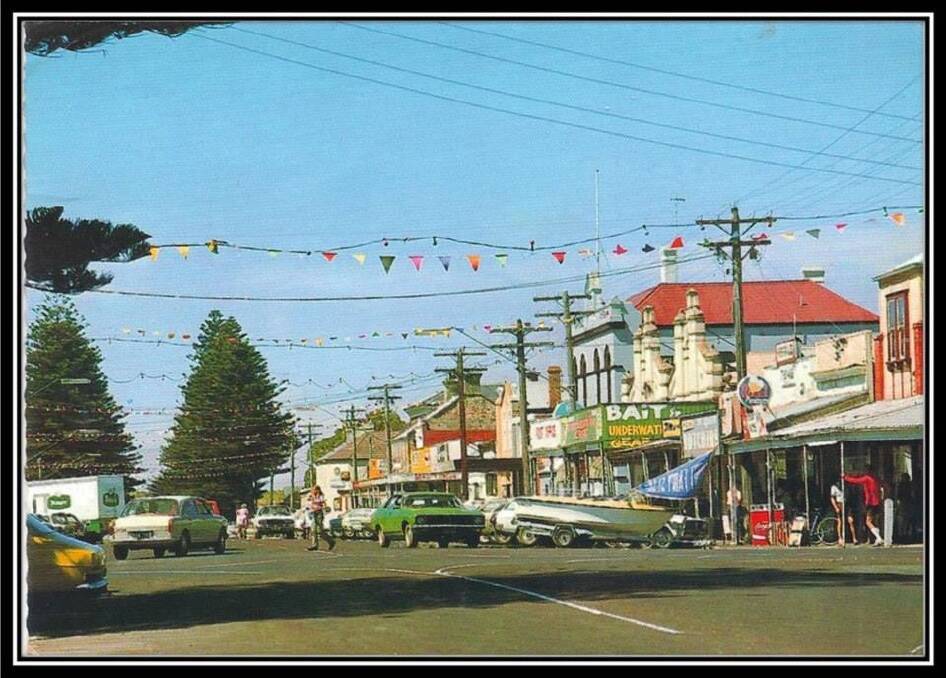COLOURFUL: A busy Port Fairy town centre back in the summer of 1976. Our thanks to the Port Fairy Historical Society for this photograph. 