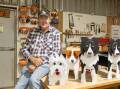 Glen Walkenhorst with plant boxes shaped like dogs at Port Fairy Men's Shed. Picture by Eddie Guerrero