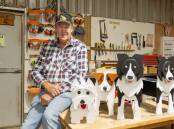 Glen Walkenhorst with plant boxes shaped like dogs at Port Fairy Men's Shed. Picture by Eddie Guerrero