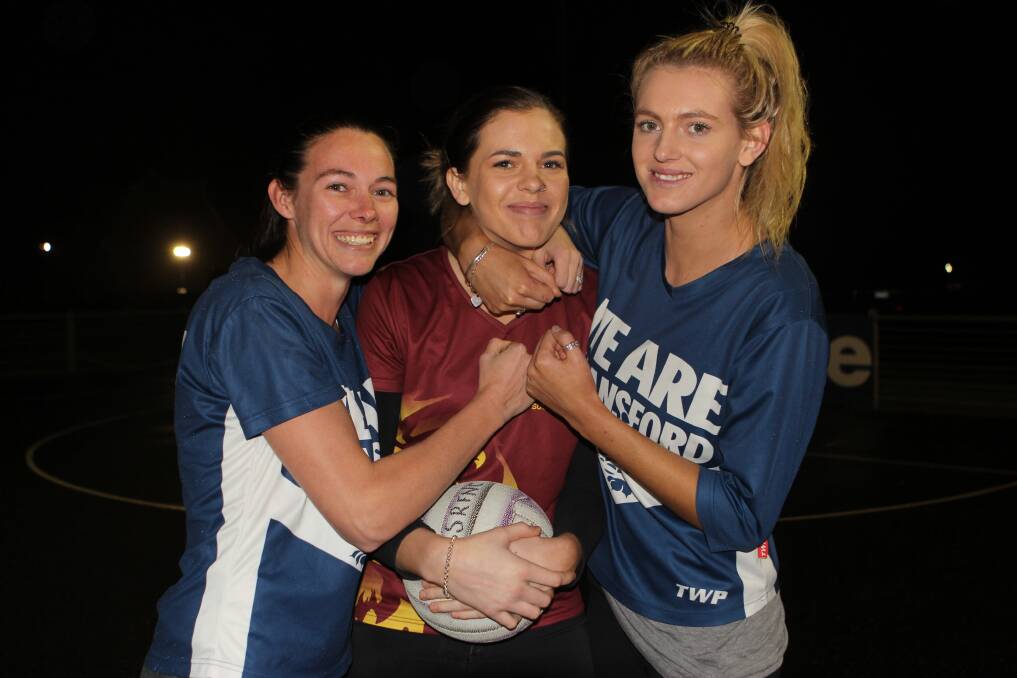 FAMILY: Sisters Stacy Mills and Rebecca Rohan rough up another sister, Jess Rohan (middle), ahead of their clash on Saturday. Picture: Anthony Brady 