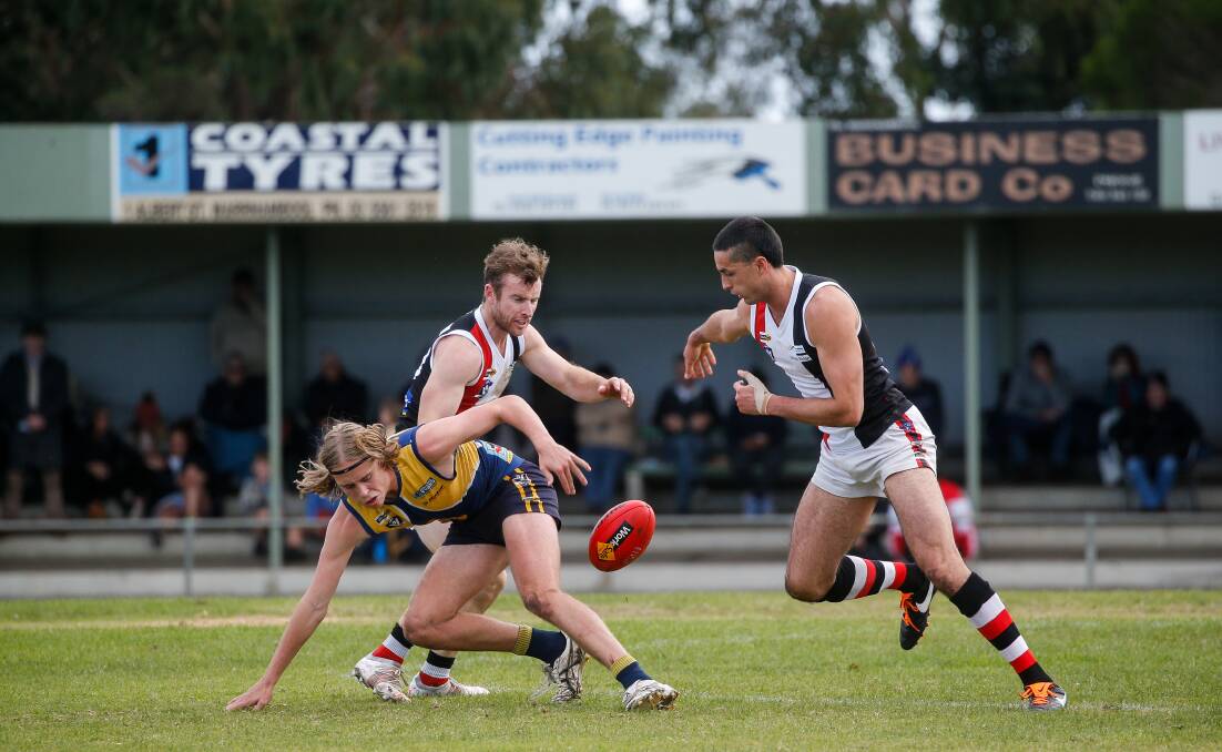 BATTLE: Brett Harrington (middle) fights for the ball earlier in the season with North Warrnamboool Eagle Jett Bermingham and Koroit's Jarrod Korewha. Picture: Anthony Brady