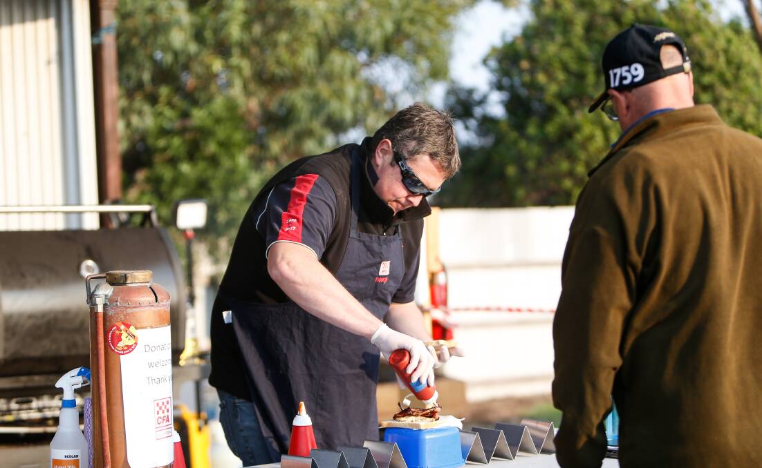 HANDS ON: Koroit CFA member Leigh Mugavin working on the barbecue at the Koroit swap meet show and shine. 