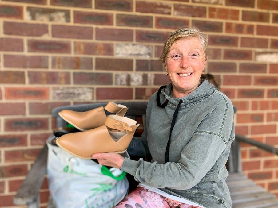 GIVING: Donations of shoes have spread beyond Koroit, with Port Fairy's Martina Murrihy at her home with some of the shoes she has donated to help fill the boxes.