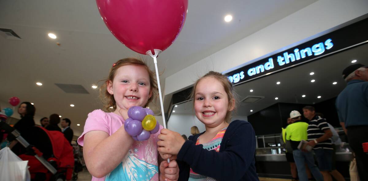 HAPPY: Ruby Williams and Isabella Malady enjoy their free balloons at the opening of the Gateway Plaza expansion. Picture: Amy Paton