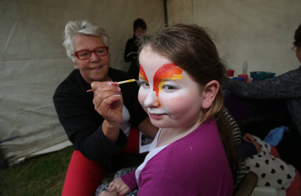 Angela Williams paints the face of Jessica Artis, 8, of Port Fairy, during the community event at the weekend. 