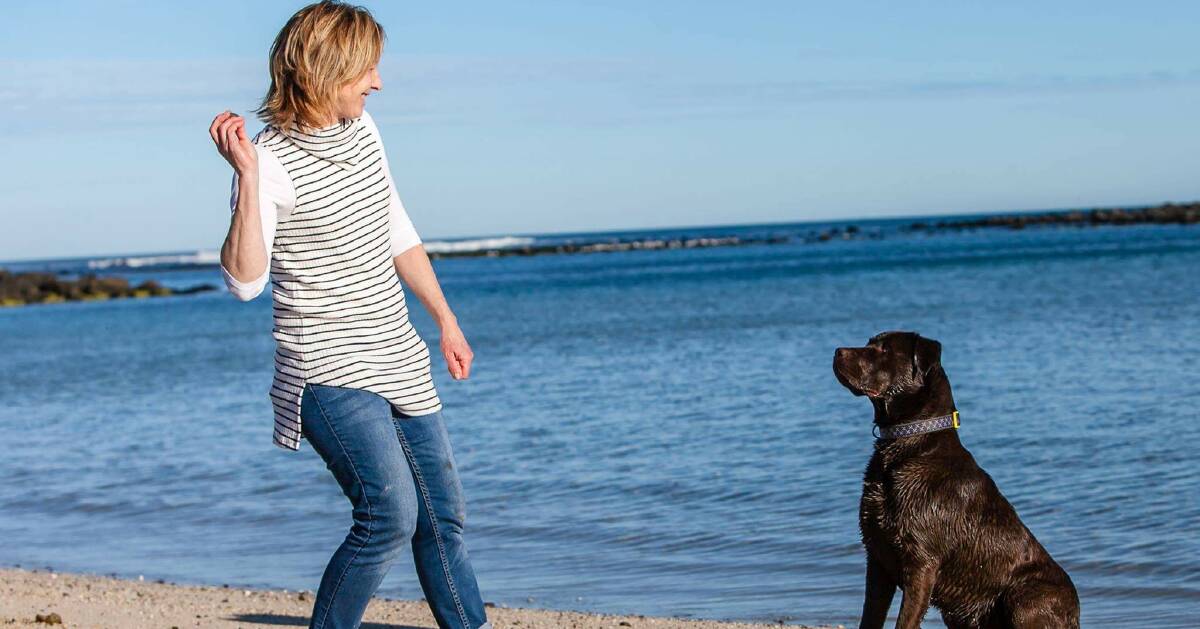 PLAY TIME: Sue Flaherty and her dog Ted spending some leisure time on the beach in Port Fairy. They will be at the Pet Appreication Day this summer. Picture: Peta Jolley
