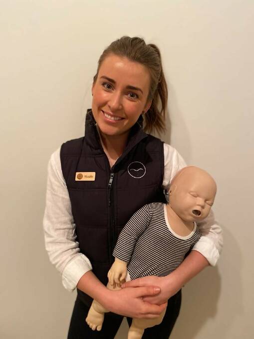 Nicole Gleeson with a dummy she will use at the first aid course.