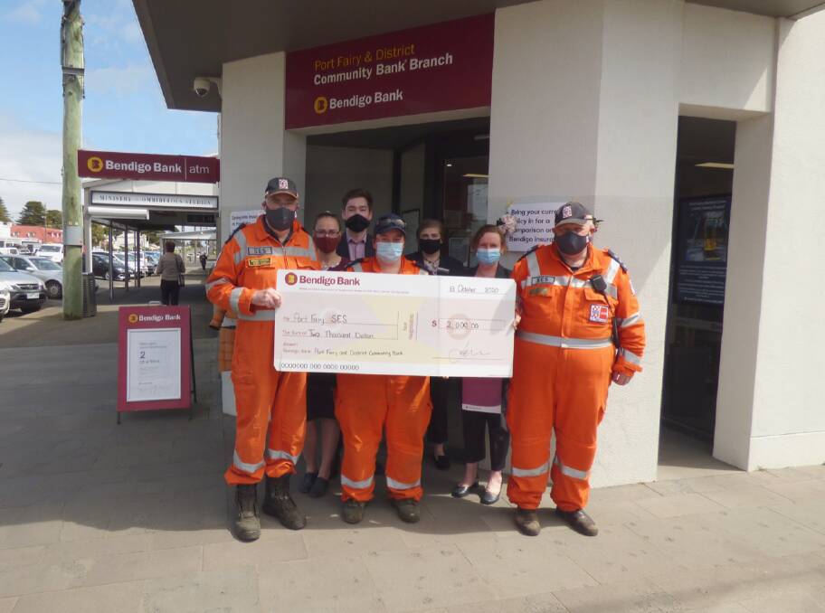 CLEANING UP: Port Fairy and District Community Bank staff present a $2000 cheque to Port Fairy SES Unit members. 