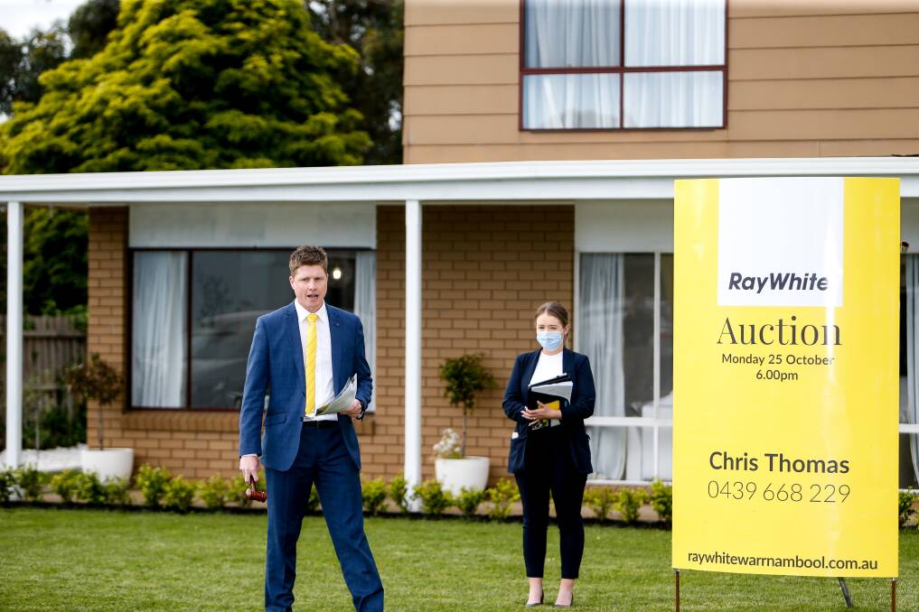 UP FOR GRABS: Ray White Real Estate agent Fergus Torpy takes bids for a house at 34 Station Street in Koroit. Picture: Anthony Brady