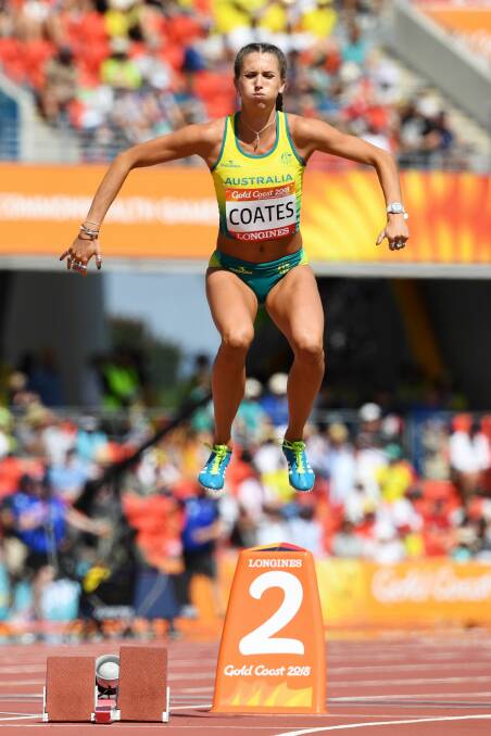 COMING: Maddie Coates leaps into the air as part of her warm up at the starting blocks for the 200 metres at the Commonwealth Games this year. 