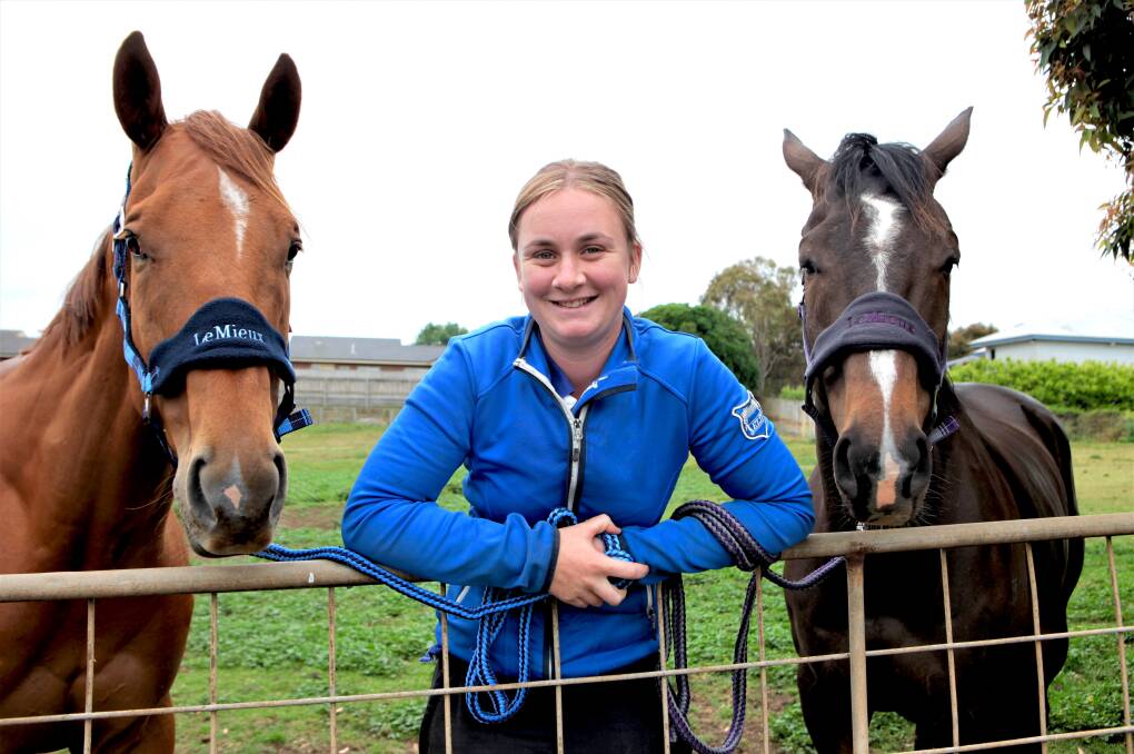 HAPPY HANDLER: Olivia Ludeman relaxes at home with her two horses, Leica Day and Contact. Ludeman has loved horses since an early age.
