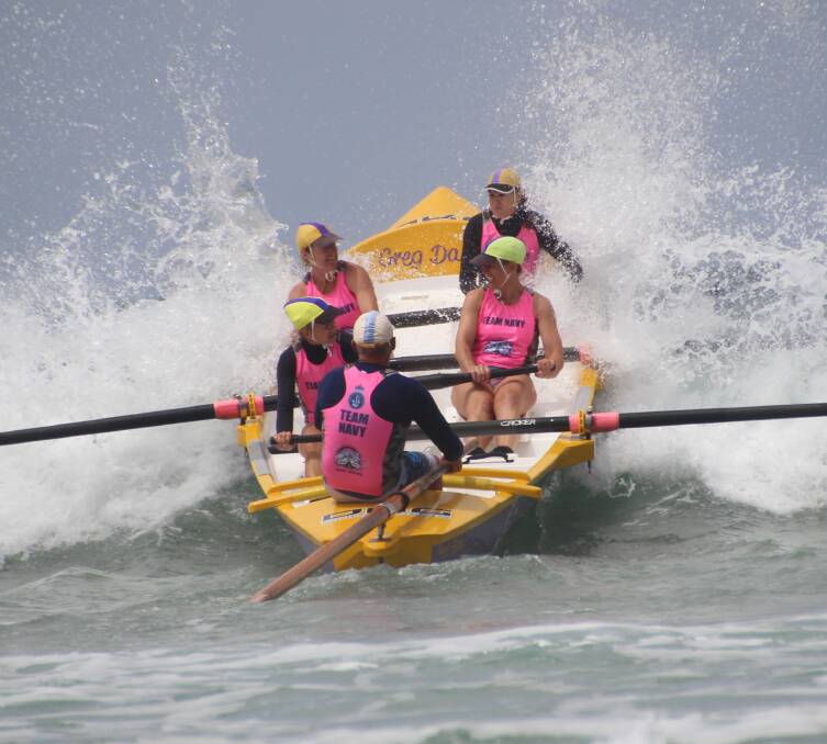 STRONG: Members of the Port Fairy Surf Life Saving Club's women's rowing crew crash through a wave at a competition in Anglesea on the weekend. They won a silver medal. Picture: Martina Murrihy