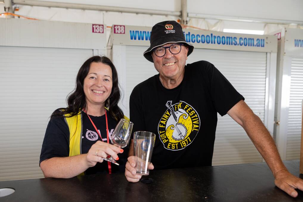 Port Fairy Folk Festival operations manager Kaylene Bant and president Bruce Leishman with the new sustainable wine and beer glasses. Picture by Anthony Brady