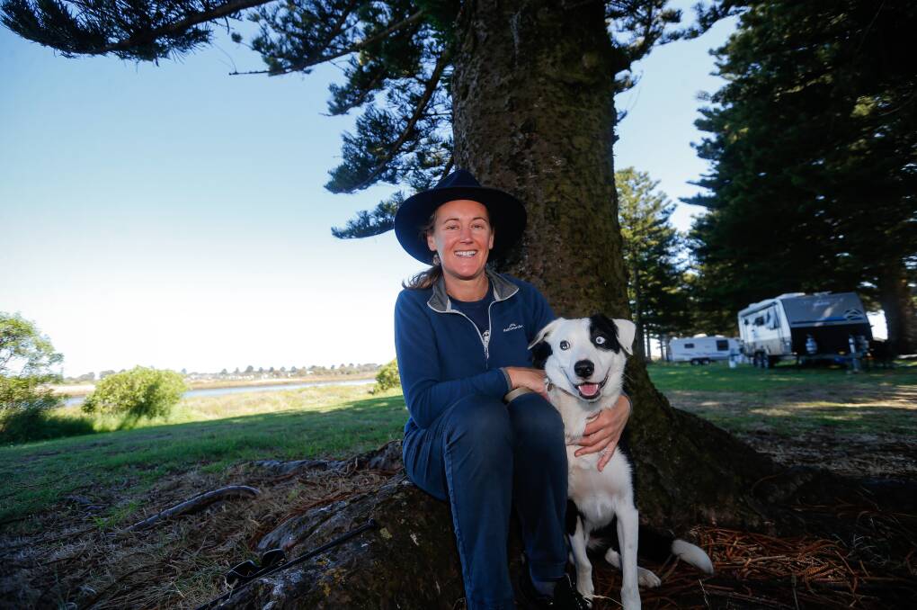 Sarah McFarlane from Seaford and her dog Max take a rest under a tree along the Moyne River during the Commonwealth Championship Sheepdog Trials in Port Fairy. Picture: Anthony Brady