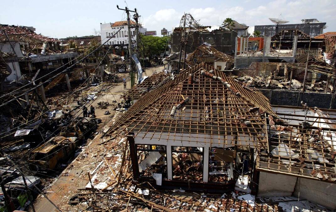 Burnt out cars and buildings in Legian street in Bali after the terror attacks on October 12, 2002. Picture by Mal Fairclough