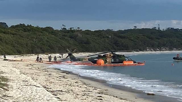 The Army's MRH-90 Taipan at Greenpatch Beach on Thursday morning after a crash on Wednesday evening where 10 people were rescued from the water off Jervis Bay. Picture by Glenn Ellard