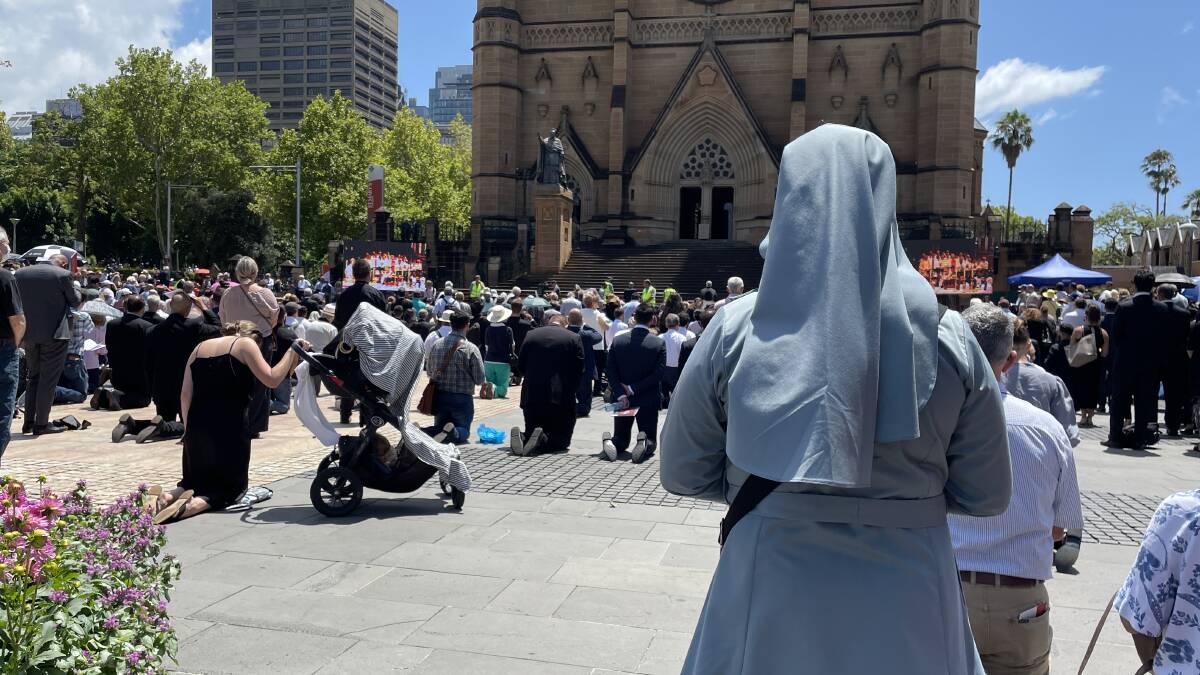 Thousands of people packed the courtyard outside St Mary's Cathedral to watch the livestream of Cardinal George Pell's funeral on Thursday, February 2, 2023. Picture by Nadine Morton