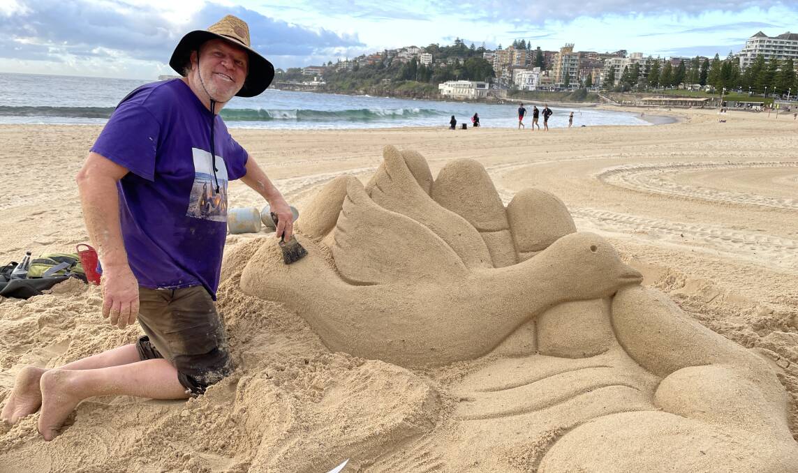 Steve Machell travelled from Lismore to create a sand sculpture on Coogee Beach in Sydney in honour of the 88 Australians who died in Bali. Picture by Nadine Morton