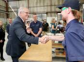 Prime Minister Scott Morrison with fourth year apprentice Jack Davie at Air Affairs Australia's Advanced Manufacturing Centre in South Nowra. Picture: James Croucher
