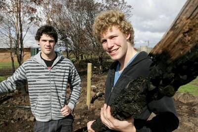 Warrnambool College students Leatham Robe and Ashley Johnstone (above) along with Cheyene Carter, VCAL leader Peter Hay and Benjamin Suridge (below) help replace burnt-out fence posts on a Pomborneit property. 090501AS01, 02Pictures: AARON SAWALL