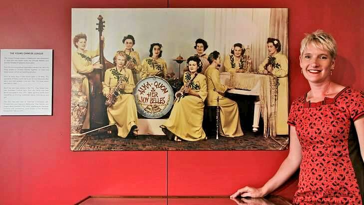 Sophie Couchman in front of a photo of Alma Quon and her Joy Belles in Melbourne's Chinese Museum. Photo: Ken Irwin