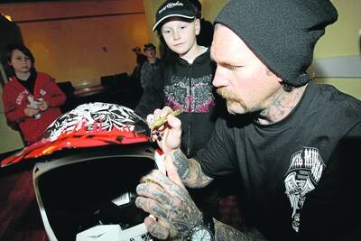 Kobi Bannam, 7, of Portland, gets his helmet signed by Crusty Demons rider Seth Enslow at the fan appreciation day at the Cally Hotel on Saturday. Picture: ANGELA MILNE