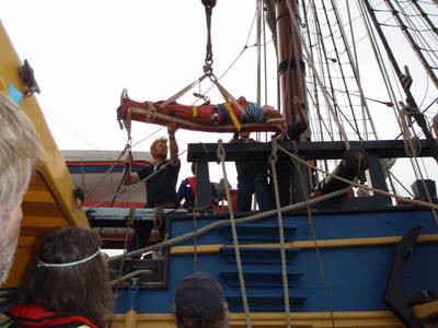 The injured man is lifted on to a coast guard vessel from the Endeavour yesterday.