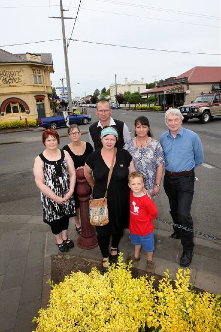 Koroit business operators want trucks to stop using the town’s main street. From left: Barb Trettin from Seaclaid Cafe, Wendy Murley, from Mickey Bourke’s Koroit Hotel, Peter Daly, from Daly IGA, residents Donna Sheppard-Wright and son Cai, 5, Donna Storey, from Sacred Stones, and resident Steve Mackey. 