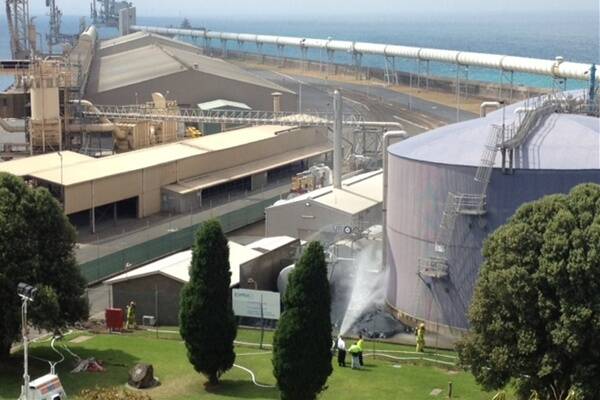 Emergency workers spray water on a chemical spill at Portland. 