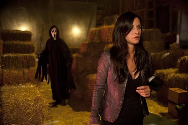 Ghostface sneaks up behind Gail (Cox) in  Scream 4 .