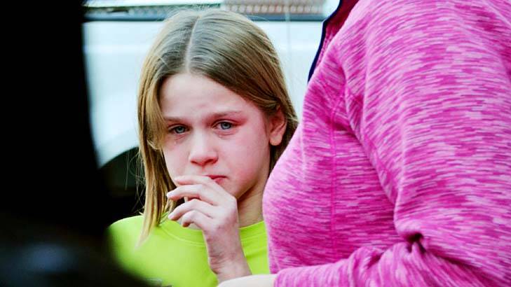 School shooting horror ... a young girl cries outside the school.