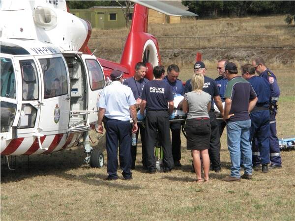 Crop duster crash pilot being transferred to air ambulance helicopter at Camperdown. Picture Mary Alexander