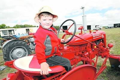Three-year-old Lachlan McLennan, from Glenfyne, looks right at home behind the wheel of a shiny red 1950 International Harvester McCormick Farmall tractor at the annual vintage rally at Cobden on the weekend.