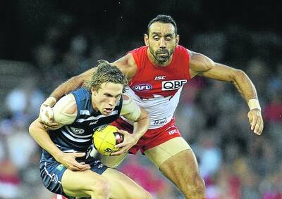 Geelongs Billie Smedts is tackled by Adam Goodes of the Swans in their round-one NAB Cup match in February. Picture: GETTY IMAGES