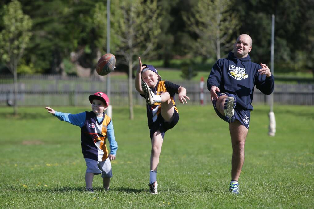New Hawkesdale-Macarthur coach Danny Chatfield has a kick with sons Kobi (left), 5, and Jyah, 7.