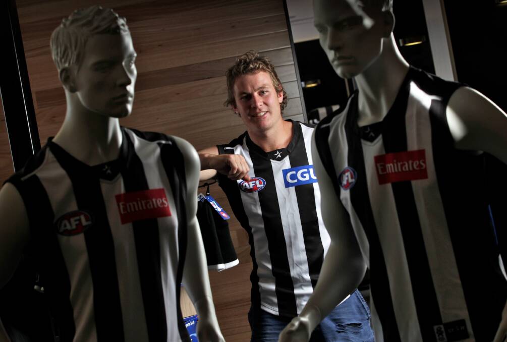 Sam Dwyer is surrounded by black and white as he ponders his AFL debut. Picture: THE AGE