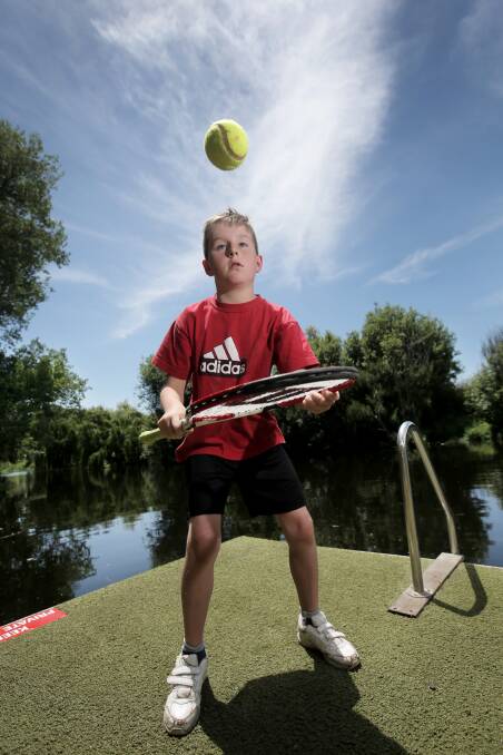 Warrnambool’s Kayne Brereton, 11, won tickets to the Australian Open thanks to a photo of him playing tennis with his brother Kye on their family’s Merri River pontoon. 